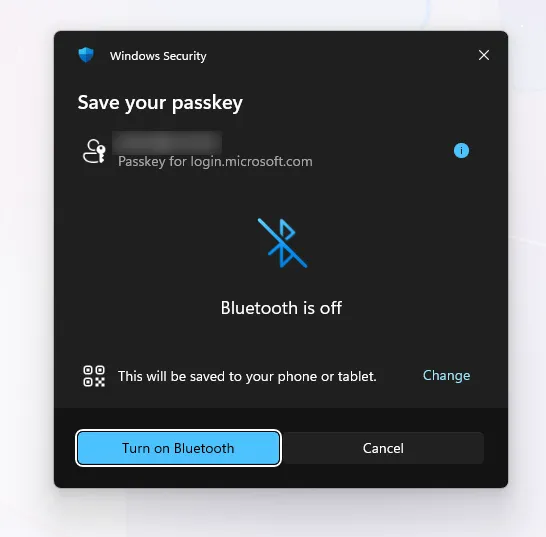 Windows Security dialog offering to save the passkey to a phone or tablet, with a Change link